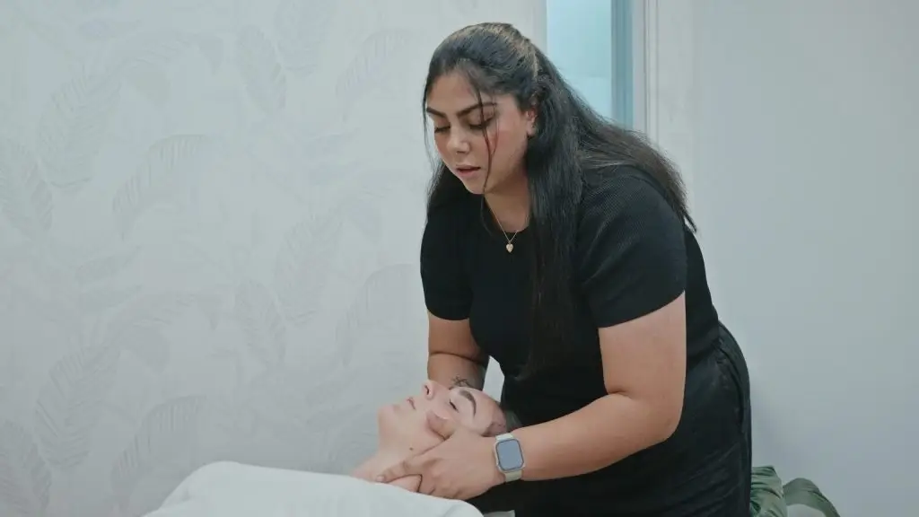 Chiropractor providing gentle neck adjustment to a patient during a chiropractic treatment session