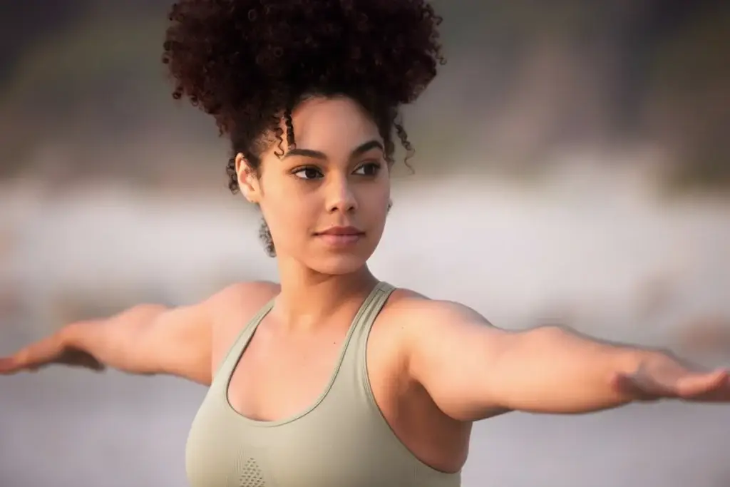 Woman performing a balance and posture exercise with arms extended